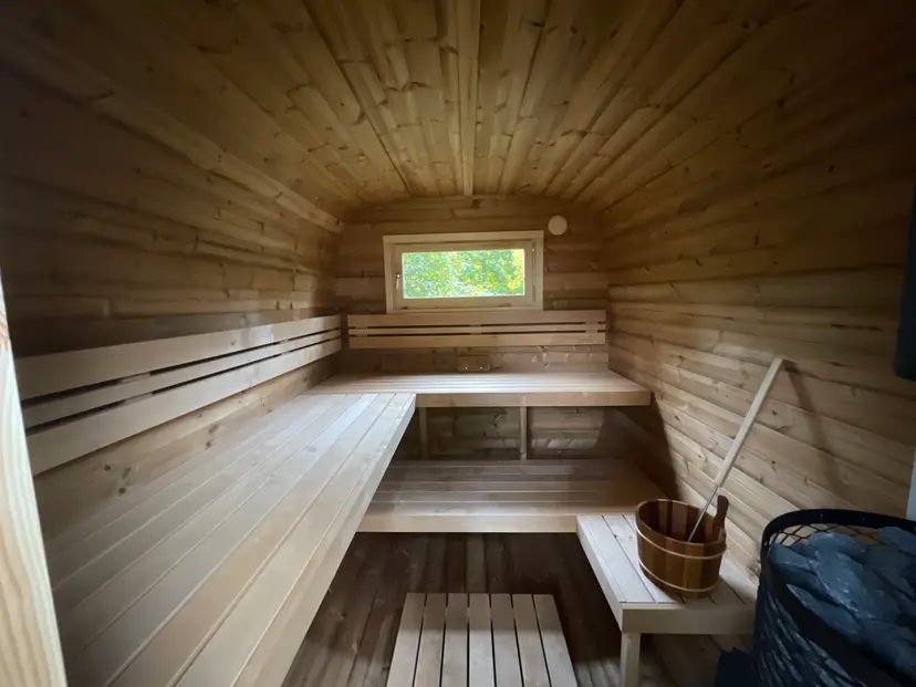 Wide cedar bench seating inside the Peak Heat wood-fired sauna
